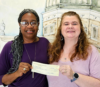 Cynthia Crosby accepts her winnings from AOP Treasurer Cynthhia Walker.