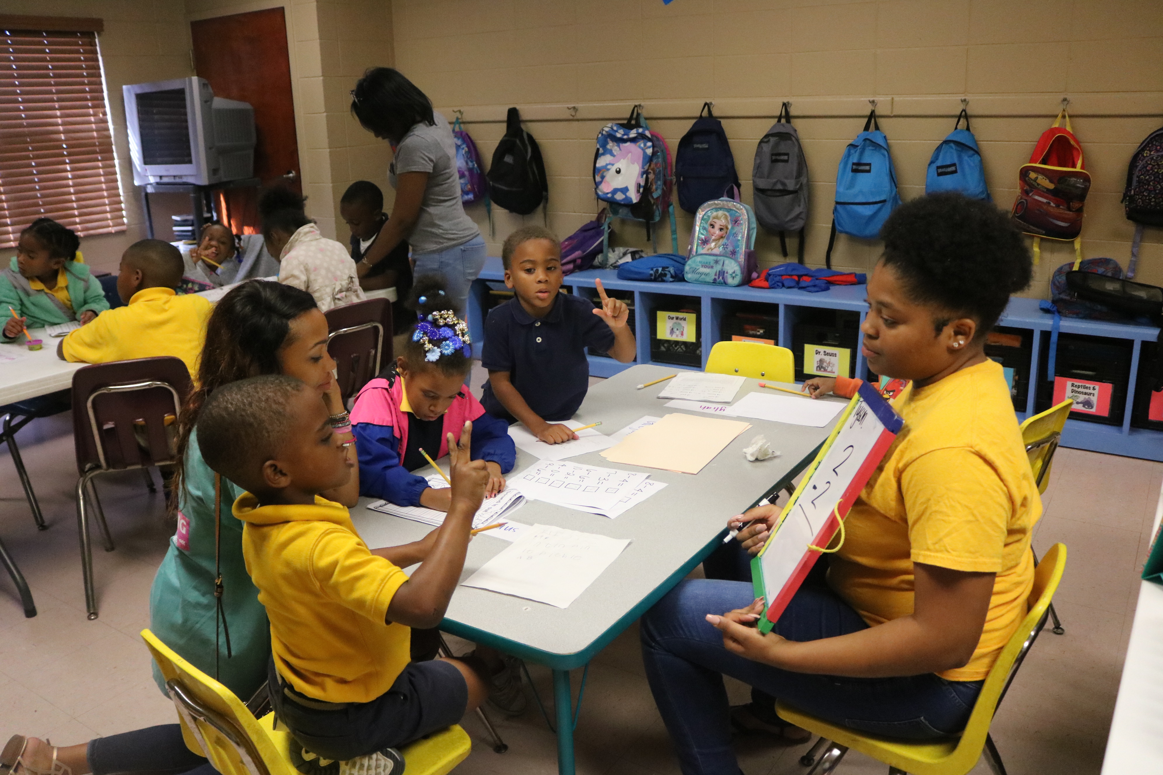 student tutoring children