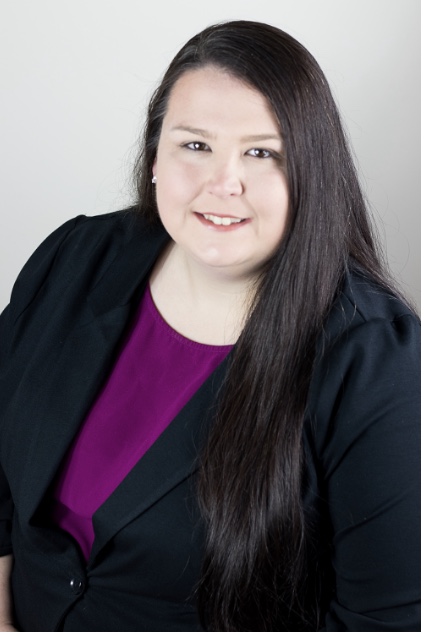 Kellie Reeves is pictured here with long, dark hair, a purple blouse, and black jacket.