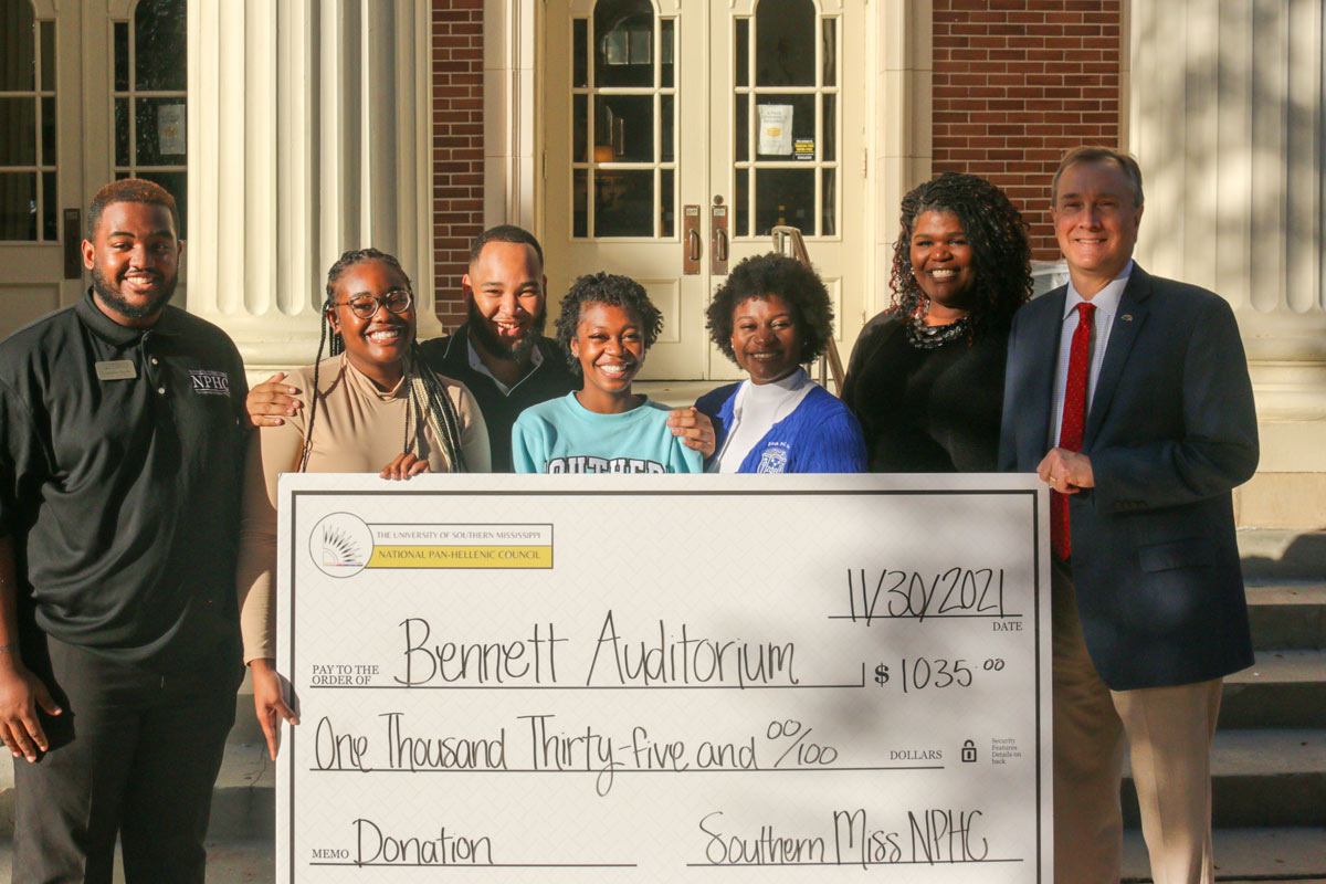 Students holding donation checks