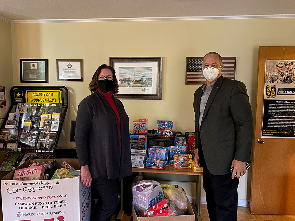 Micheal and Valerie with the toys delivered to the Toys for Tots program