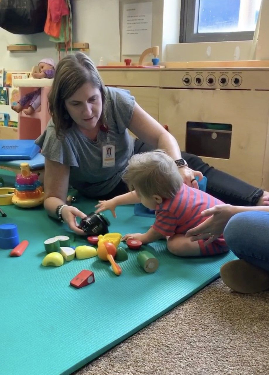 Monica Bridges playing with a child