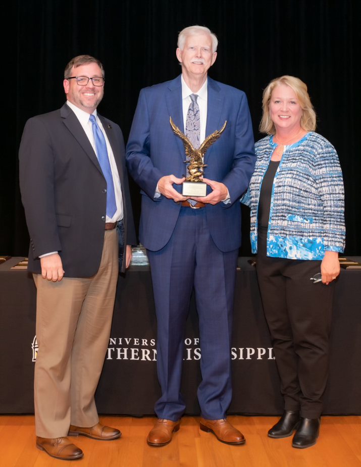 Southern District Transportation Commissioner an USM alumnus Tom King, center, is presented the Friendship Oak Award by Interim Associate Vice President for Academic Affairs, Dr. Jacob Breland, left, and Senior Associate Vice President for Coastal Operations Dr. Shannon Campbell, right, during the USM Gulf Park Awards Day Ceremony April 13.