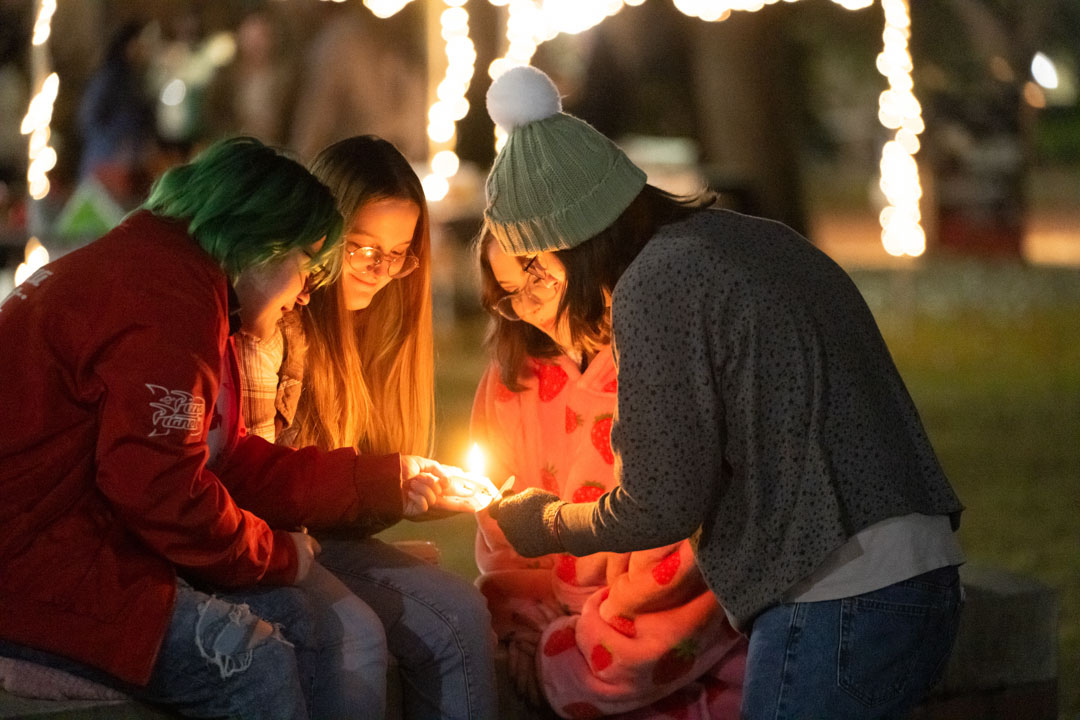 Students light candles at Lighting the Way 2023 Joe Paul at Lighting the Way 2023 / Photo by Kelly Dunn